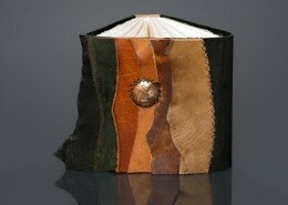 Teresa Merriman Mixed Media Artist of Mind's Eye Journals in Colorado uses traditional and contemporary bookbinding methods to create journals out of leather, handmade or watercolor paper and acid-etched metals.