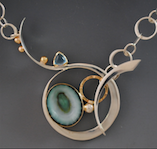 Barbara Umbel, jeweler in Indian Harbour Beach, Florida, creates pendants, necklaces and bracelets with precious metals, gemstones, sea shells or sea urchins.