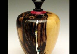 John M. Russell, Woodworker in Linden, Virginia lathe turns wood vessels and writing tools with inlaid semi-precious gems, pewter, applied gold or silver wire.
