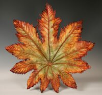 John Wayne Jackson, mixed media artist in Black Mountain, NC, creates contemporary sculptures using real leaves, a stone medium, and paint.